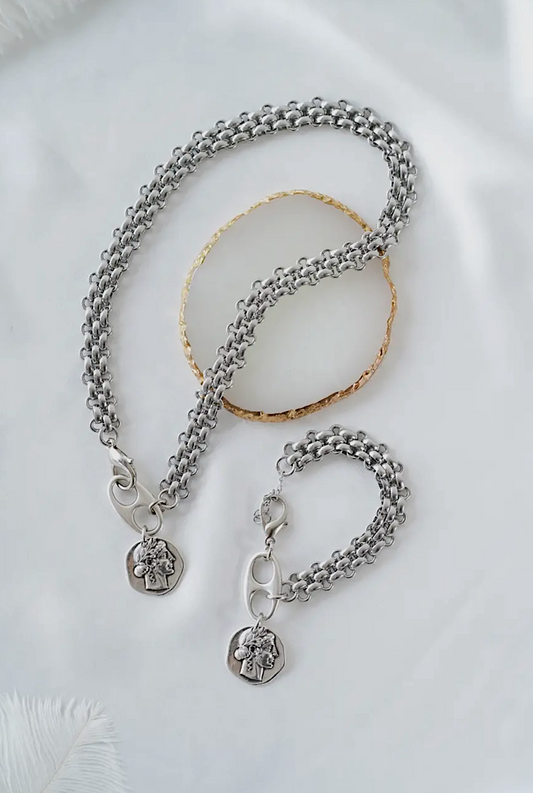 Silver necklace with chain and pendant on a white background