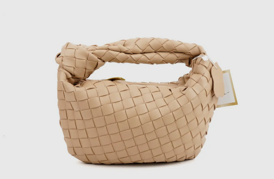 Beige woven handbag with a tag on a white background